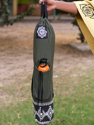 Carrying a Yoga Mat Bag in green with a black-and-white tribal block print, they hold an orange water bottle in the bags pocket. Their matching attire complements the bags versatile design, making it ideal for any active yogi outdoors.