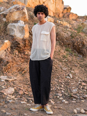 Full-length view of the Aeson T-Shirt mesh tank worn with wide-leg trousers