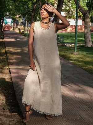 Afra Maxi Dress natural colourway with arms raised under forest canopy