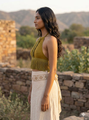 Three quarter side view of the mustard yellow Amra fringe halter crop top
