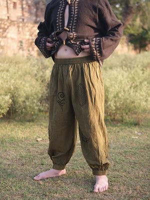 Hand printed olive harem jogger pants styled with an embroidered black jacket