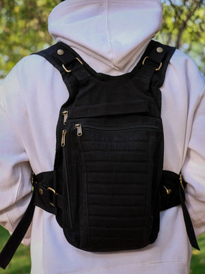Black Enigma Ninja Bag worn as a chest rig over a white hoodie, three zippered compartments facing front