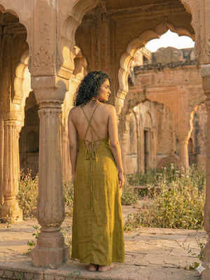 Idhika Dress in olive green, back view showing criss-cross straps and tie waist at a haveli