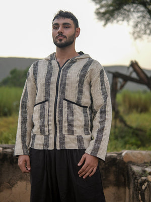 Front standing view of the striped hooded jacket with hands at the hem, showing the straight hem and stripe run