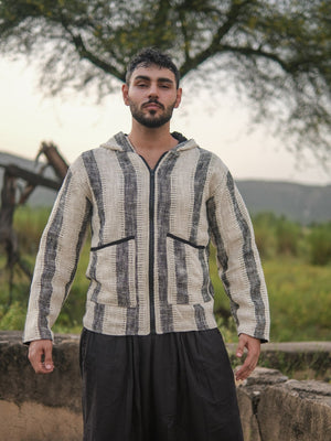 Front view of the striped hooded jacket in ivory and charcoal cotton, hood down, zip closed, on a male model