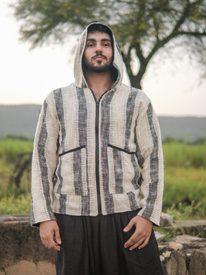 Ivory and charcoal striped hooded jacket worn with the hood up, front view showing the black zip and pockets