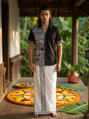 Flat-lay of the black Koothu Kathakali shirt, half sleeves and printed side panel visible on a plain surface.
