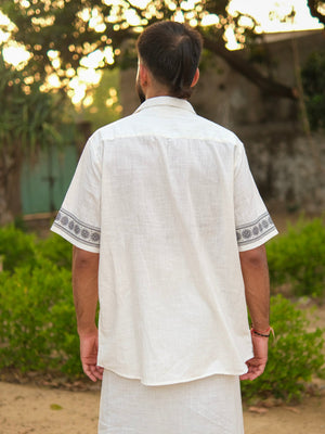 Back view of the Koothu Kathakali shirt, plain cotton slub fabric with mandarin collar and natural-look buttons.