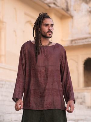 Man wearing the maroon Om print kurta with long sleeves and a plain faced boat neckline