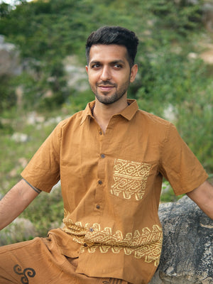 Man seated in mustard yellow tribal handblock cotton shirt, relaxed fit