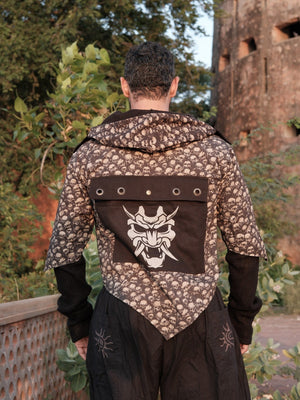 Raaz Jacket back view with the white demon-mask graphic panel, eyelet flap and pointed hem on the cotton hooded jacket
