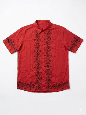 Flat-lay of the red Raksha Shirt showing the geometric block print band, chest pocket and button placket