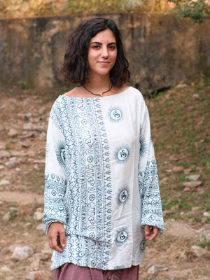 Woman in the white and blue Om print kurta, vertical Sanskrit script panels down the front