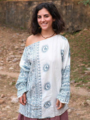 White kurta with blue Om medallions worn off one shoulder, full printed sleeves