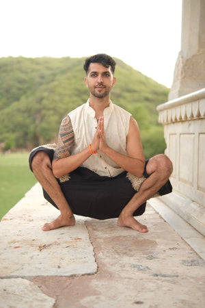 Black Yogi Palazzo Pants worn in a seated yoga squat, showing the ankle length hem