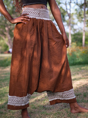 Brown Yogi Palazzo Pants on a female model, front view with hands on hips