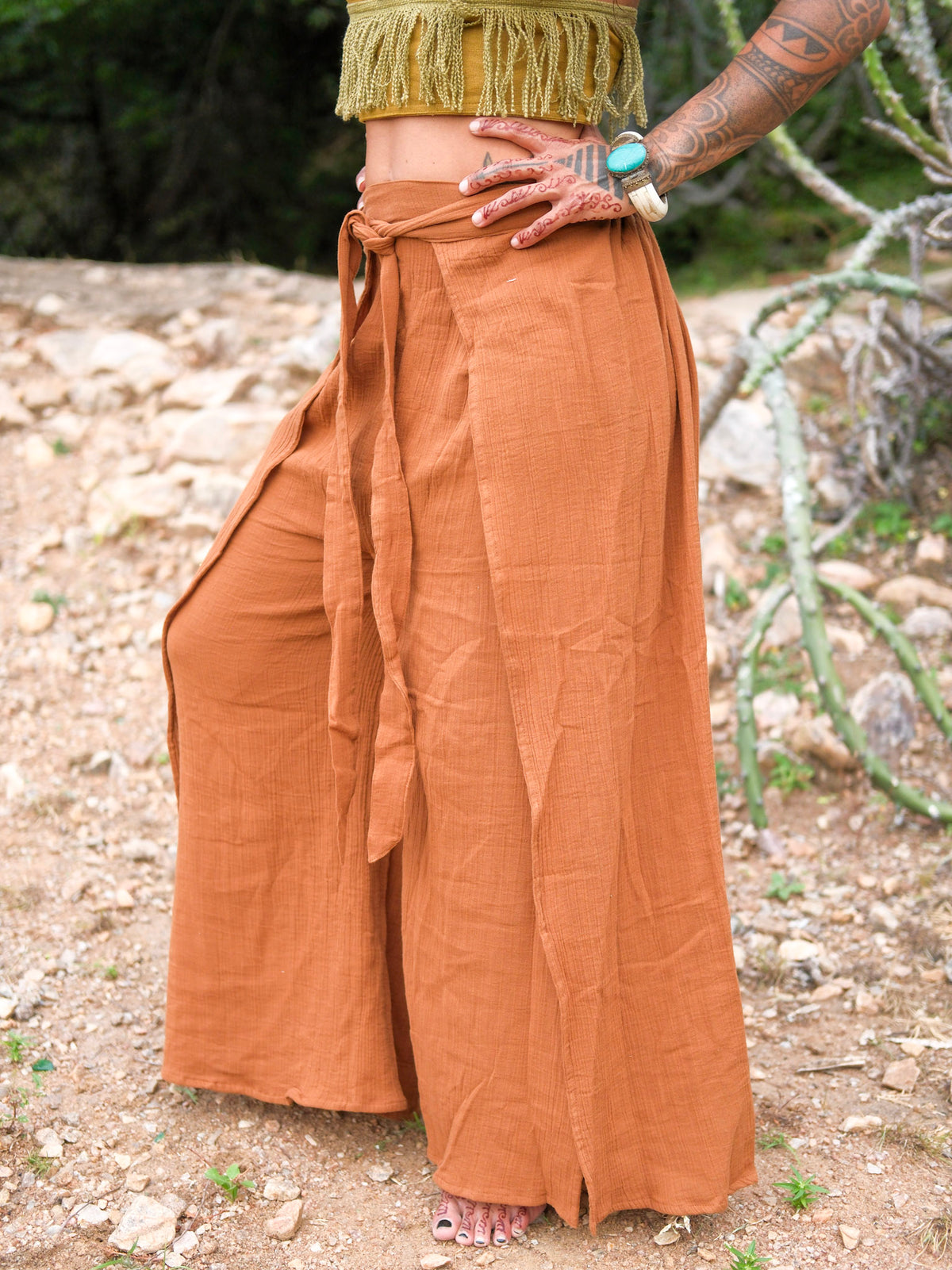 Preet Wrap Pants in terracotta, featuring a high-waisted, boho wrap design with a tied waistband and wide, flowing legs.