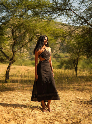 Aadhya black block print cotton maxi dress standing in a golden field with arms crossed