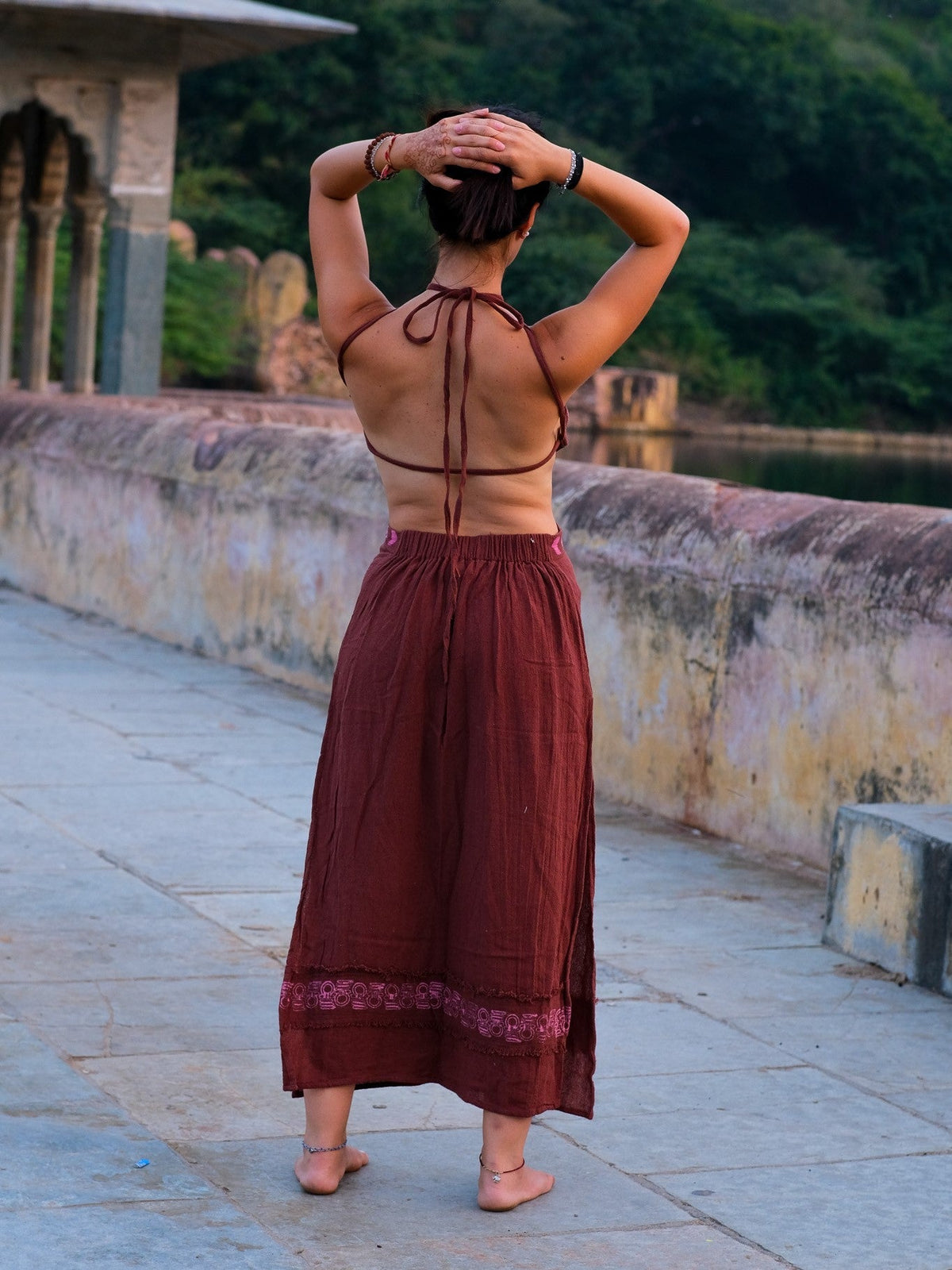 Back view of the Aadhya maroon block print cotton maxi dress showing the halter neck ties and cut-out back
