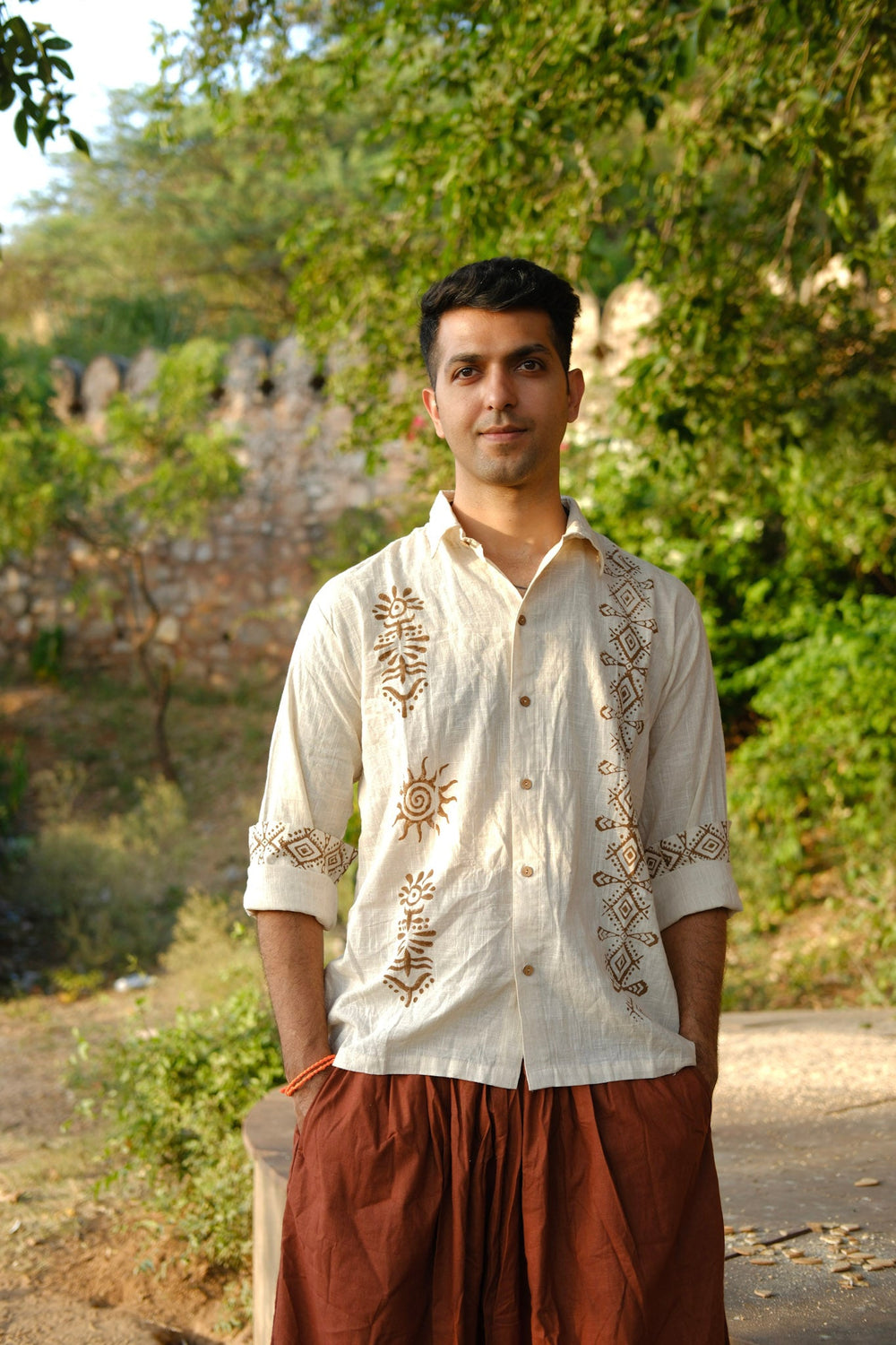 Men's off-white hand block print cotton shirt, front view with rust sun and diamond motifs