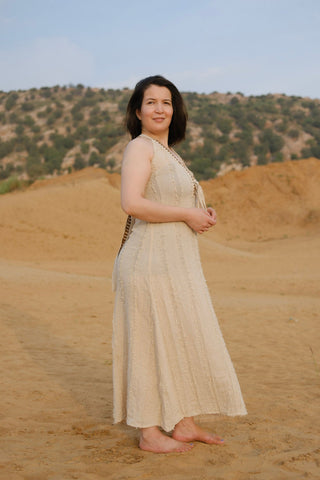 Aaven Crossback Dress in natural cream, side profile of the flowing one-size boho maxi dress