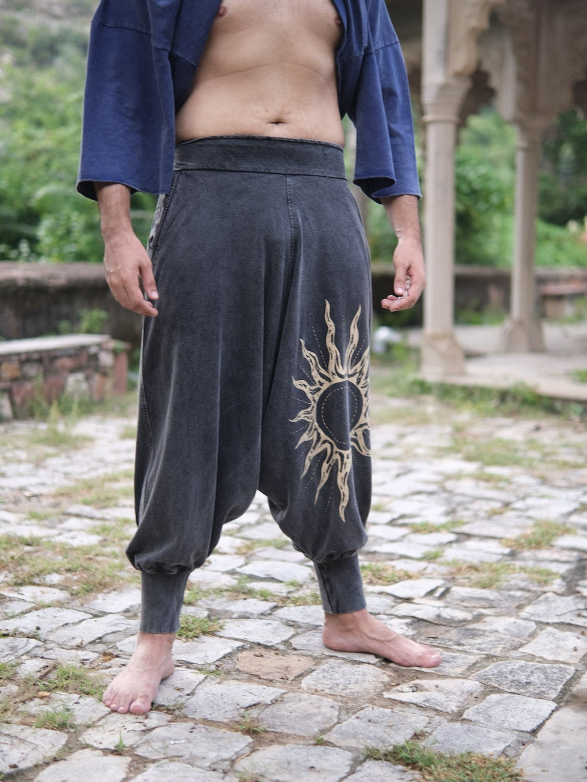 Front view of the elasticated waistband and deep side pockets on the grey harem pants