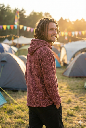 Three-quarter back view of the maroon hooded jacket in golden-hour light, hood resting down, tents and bunting