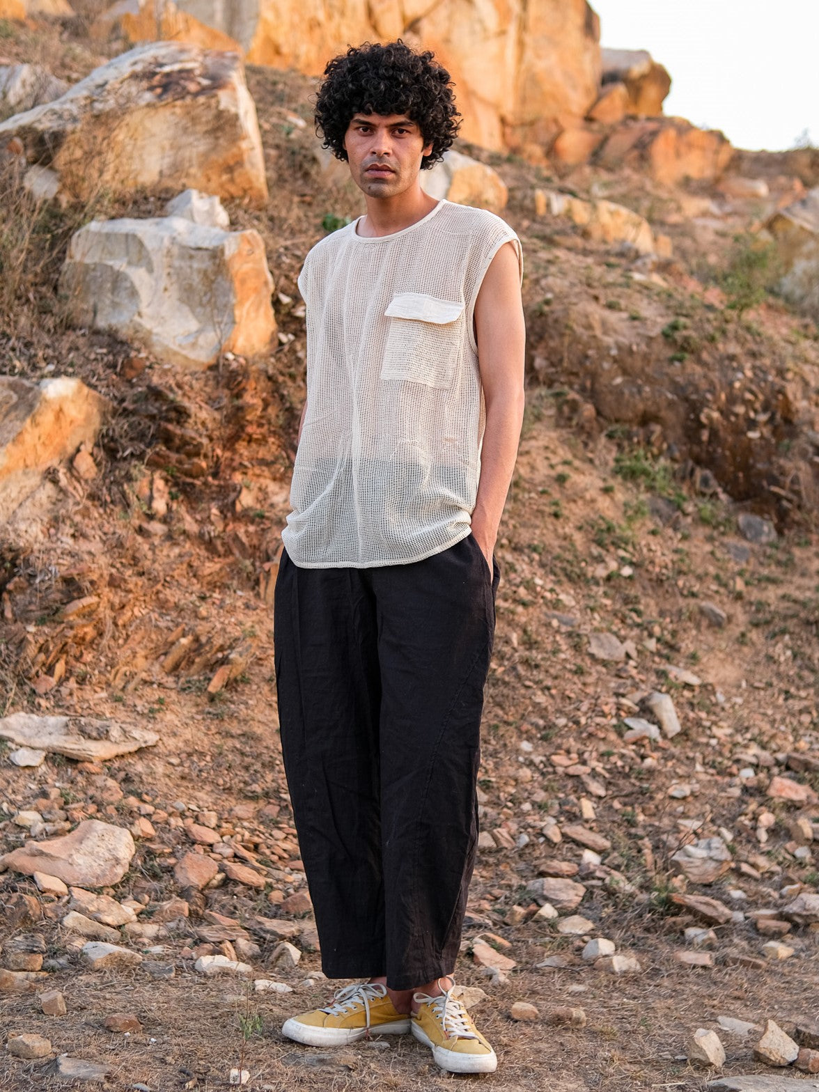 Full-length view of the Aeson T-Shirt mesh tank worn with wide-leg trousers