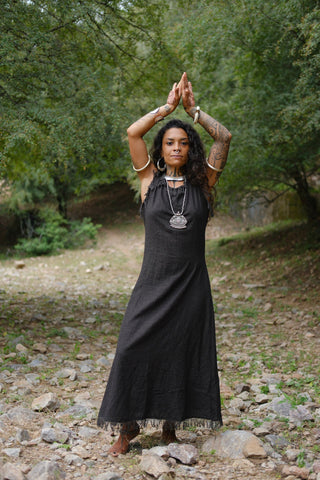 Afra Maxi Dress in black cotton, standing pose in shaded forest clearing