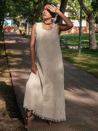 Afra Maxi Dress natural colourway with arms raised under forest canopy