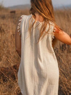 Afra Maxi Dress back view showing fringe trim along armholes in cream cotton