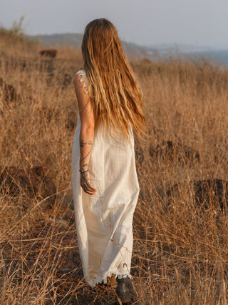 Afra Maxi Dress back view in cream cotton on model walking through dry golden grass