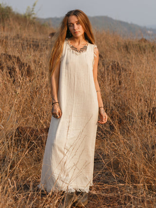 Afra Maxi Dress in natural cream cotton, full length front view in dry grassland