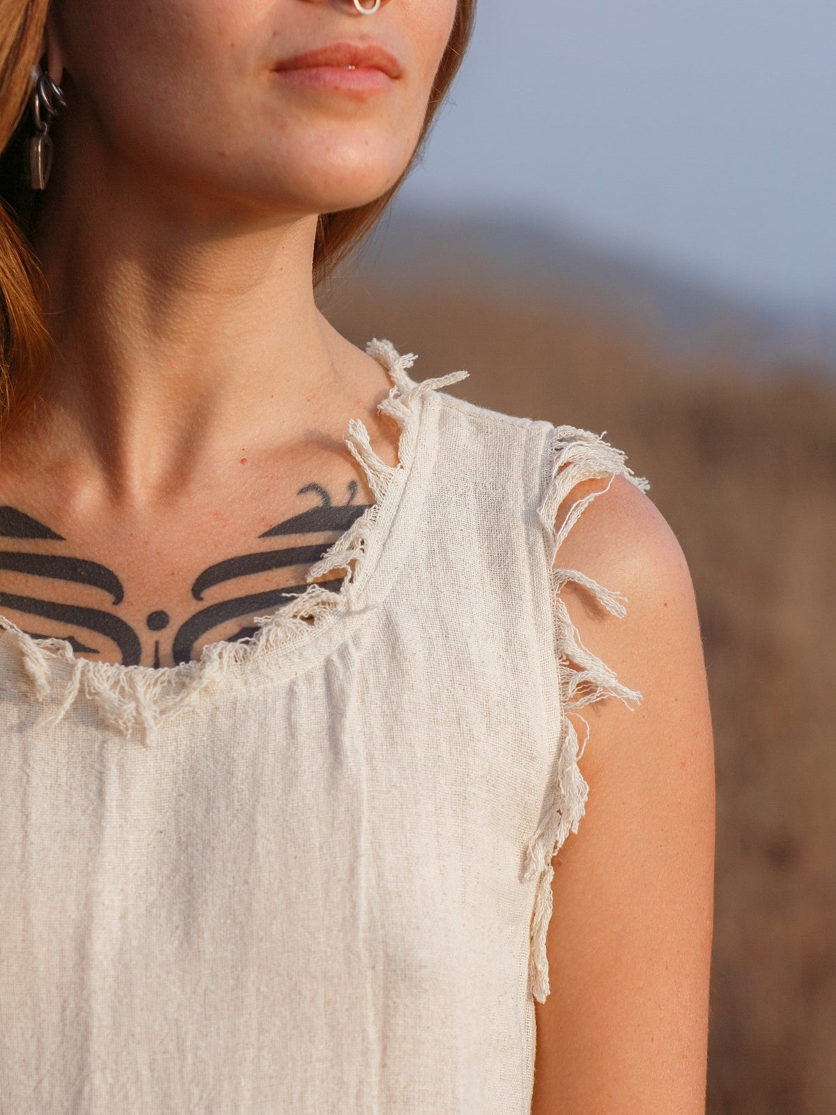 Afra Maxi Dress close up of fringe-trimmed neckline and raw armhole edges in cream cotton