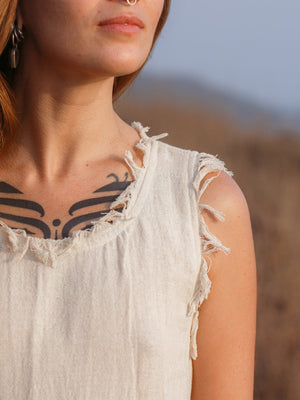 Afra Maxi Dress close up of fringe-trimmed neckline and raw armhole edges in cream cotton