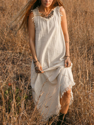 Afra Maxi Dress cream fringe-trimmed neckline detail held by model in dry grass