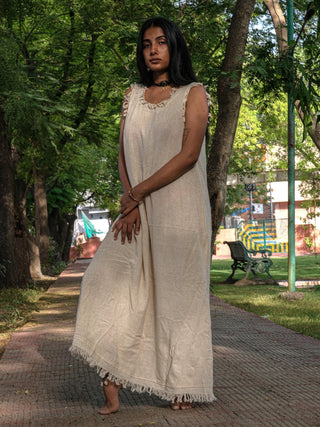 Afra Maxi Dress natural sleeveless maxi with fringe hem on a tree-lined park path