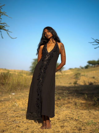 Alaya Dress black fringe halter maxi, three-quarter pose in desert landscape