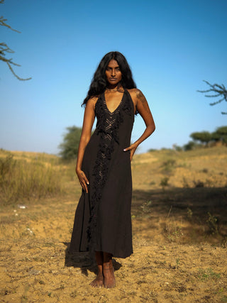 Alaya Dress black fringe maxi full front view, desert scrubland backdrop