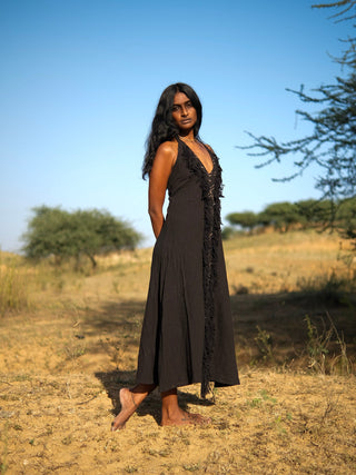 Alaya Dress forest green fringe halter maxi, model in temple courtyard, front view