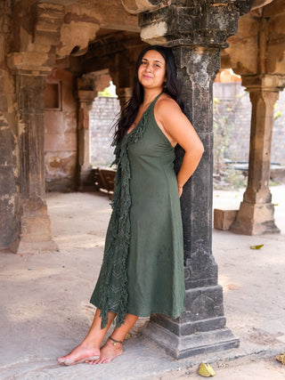 Alaya Dress forest green fringe halter maxi, model in temple courtyard, front view