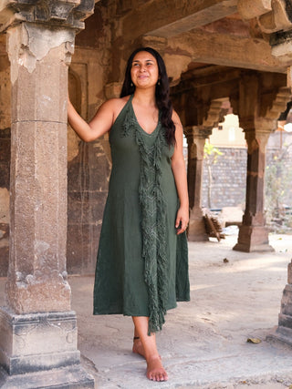 Alaya Dress forest green halter maxi with front fringe, model side view in heritage temple arches