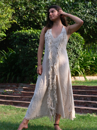 Alaya Dress natural handwoven cotton fringe maxi, model in garden, front view