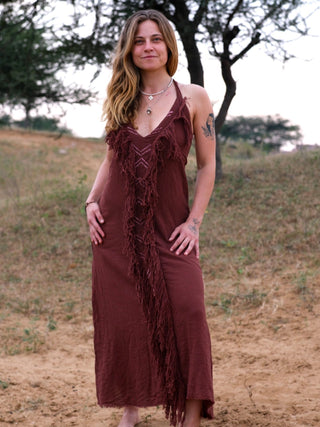 Alaya Dress wine-brown fringe halter maxi, model in arid landscape, front view