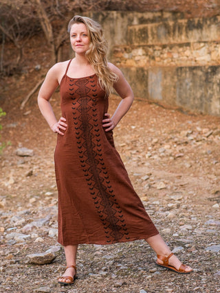 Model walking in the Anusrava brown block print cotton maxi dress, one hand on her hip, showing the full flare at the hem