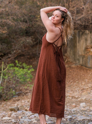 Back view of the Anusrava maxi dress showing the thin crossback straps and the brown tie knotted at the centre back