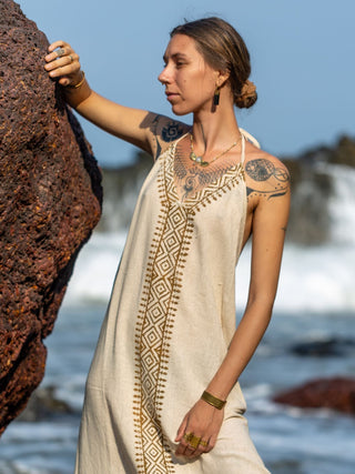 Natural Aurora halter maxi dress on the shore, front of the tribal print panel in focus