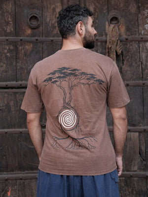 Back view of a brown cotton t-shirt showing the black acacia tree print and white spiral motif, worn by a model