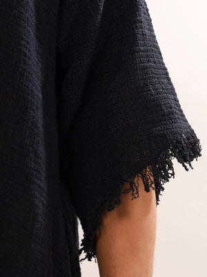 Close-up of the black T-shirt sleeve showing the open weave and softly frayed raw sleeve edge