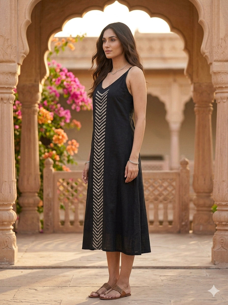 Manthan black embroidered midi dress from the side, relaxed A-line with fine spaghetti straps